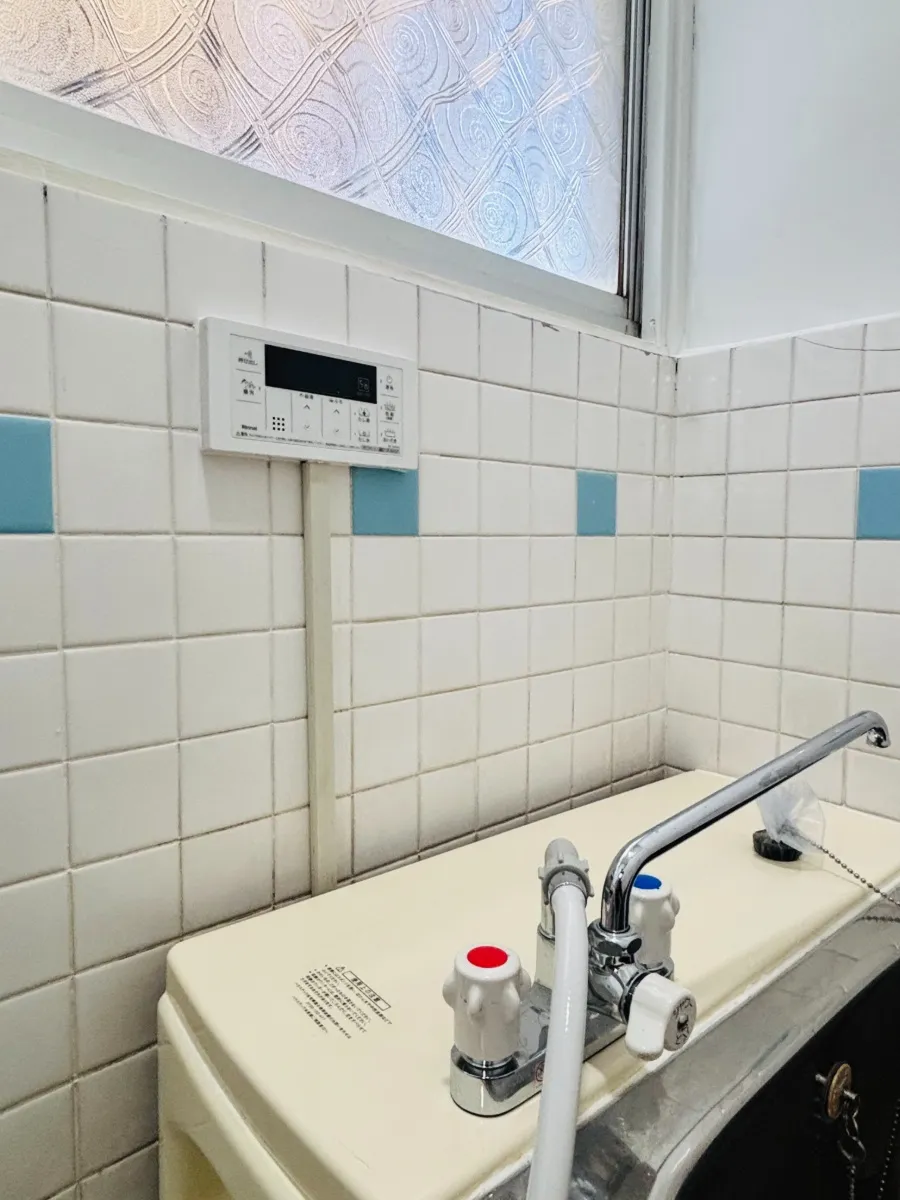 close-up-of-old-bathroom-faucet-and-tiles